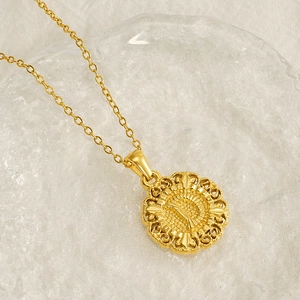 Polished 18K gold-plated stainless steel circular hollow pattern necklace on glass
