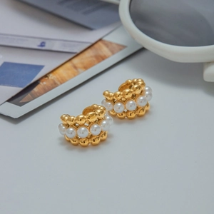 Detail of 18K gold stainless steel hoop earrings with alternating white pearls