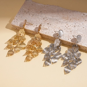 Golden and silver metal leaf tassel earrings with cat-eye stone accents on stone base