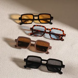 Retro rectangular sunglasses in four colors with gradient lens shadows on textured wall