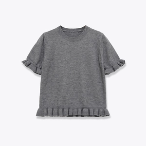 Detail of grey knitted short sleeve top featuring ruffle hem and lettuce trim cuffs