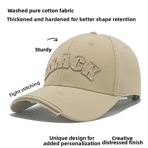 Detailed shot of khaki baseball cap with distressed brim and BLACK embroidery patch