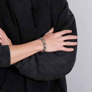 Close-up of a men's silver stainless steel bracelet with boxing glove link design