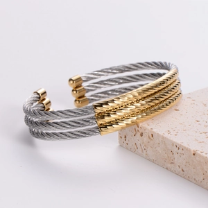 Three-layer steel cable cuff bracelet in two-tone gold and silver minimalist design