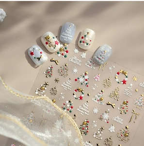Close-up of 3D embossed Christmas nail stickers with gold tree and snowflake motifs