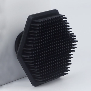 Macro view of black hexagonal silicone face brush with dense exfoliating bristles