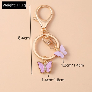 Detail view of pink butterfly keychain with golden plating and specific size dimensions