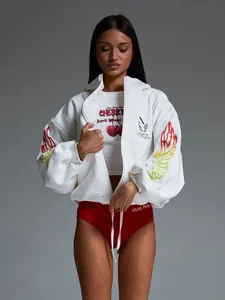 Detail of white zip-up hoodie featuring vibrant gradient wing prints on the sleeves