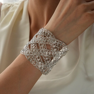Detail shot of vintage silver mesh weave open cuff bracelet on a female model
