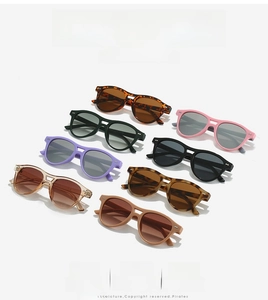 Flat lay of eight multi-color retro oval sunglasses with rivet details for fashion styling