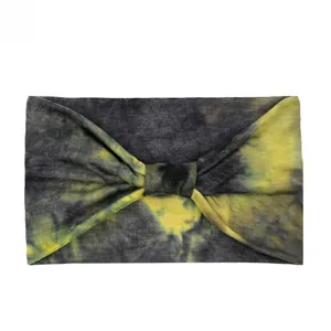 Detail of gray tie-dye wide headband with center knot and yellow splatter pattern