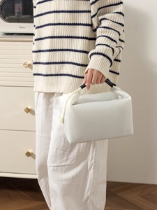 Close-up of minimalist white insulated lunch bag featuring semi-transparent mesh texture