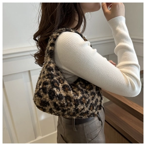 Close-up of fluffy leopard print shoulder bag featuring soft plush texture and vintage style