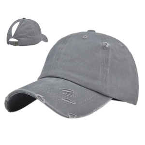 Close-up of light gray ponytail baseball cap with distressed details and back opening