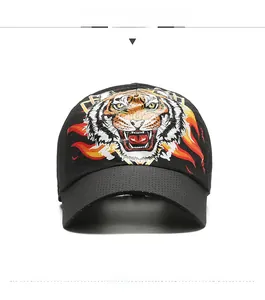 Detail of tiger head print and flame embroidery on black breathable mesh baseball cap