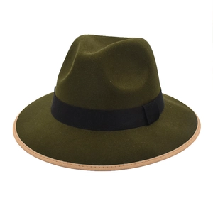 Detailed top view of dark green wool fedora with black ribbon and light brown brim edging