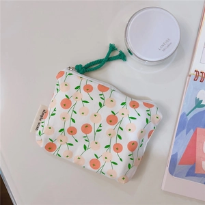 Floral cotton pouch with orange berry print and green zipper pull for lipstick storage