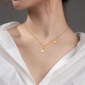 Minimalist titanium steel rabbit necklace with gold plating and star pendant on a model