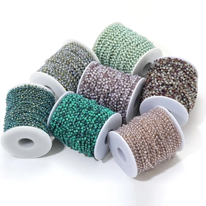 Close-up of stacked colorful 3.5mm crystal bead chains in purple and green tones