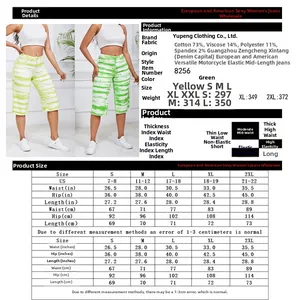 Detailed size chart for mid-length stretch denim shorts in yellow and green