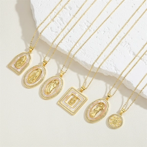 Golden religious necklaces with Virgin Mary pendants and mother of pearl on marble base