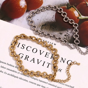 Detail of chunky gold and silver round link chain bracelets with lobster clasp closure