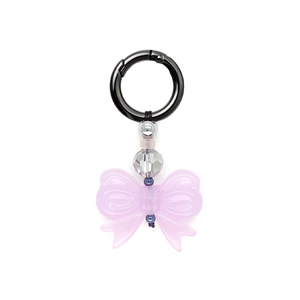 Close-up of pink bow keychain with black ring and transparent iridescent beads
