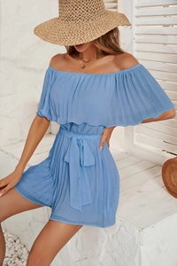 Detail of light blue off-shoulder pleated romper with waist tie and textured fabric