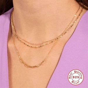 Layered 925 sterling silver necklace with cross and star charms on gold chain links