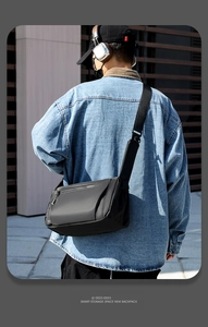 Outdoor shot of a waterproof black crossbody backpack with smart storage and adjustable strap