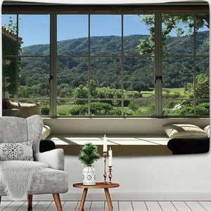 Detail view of a forest landscape tapestry hanging over a sofa in a modern room