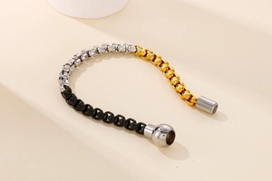 Macro shot of industrial tri-color chunky chain link bracelet with large magnetic ball clasp