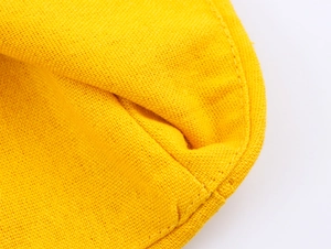 Detail of yellow cotton fabric showing high-quality stitching and woven texture