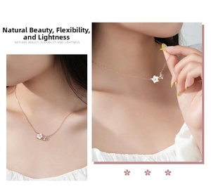 Detailed view of cherry blossom necklace with white shell petals and inlaid diamonds