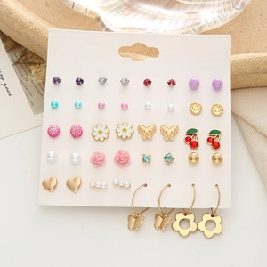 Detailed close-up of a 16-pair variety earring set featuring hearts and pearls