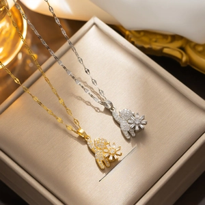 Rotating cat pendant necklace with pavé cubic zirconia in gold and silver finish