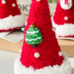 Macro view of plush Christmas hat hair clip with resin tree and pearl details