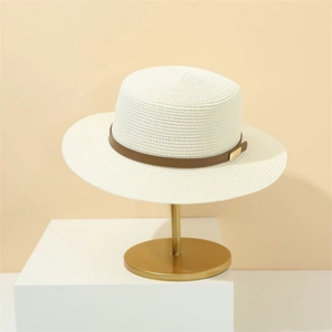 Classic beige wide brim straw boater hat with leather band on elegant gold display stand