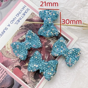 Detail shot of sparkling blue rhinestone bow bead for jewelry DIY sized 21mm by 30mm
