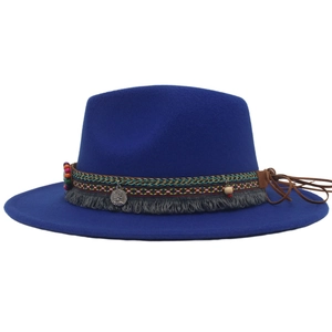 Detail of royal blue fedora hat with bohemian embroidered band and silver coin charm