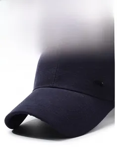 Close-up of dark grey baseball cap showing twill fabric texture and small metal logo