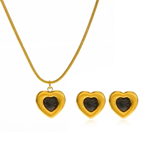 Golden heart jewelry set with necklace and stud earrings featuring black stone inlay