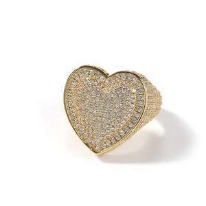 Macro shot of gold-plated hip-hop ring featuring a large heart paved with clear zircons