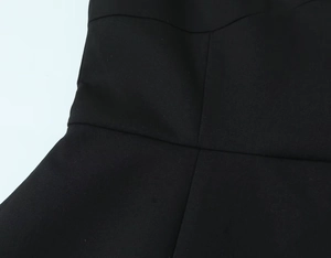 Détail de la couture à la taille et de la texture du tissu d'une mini-robe d'été noire