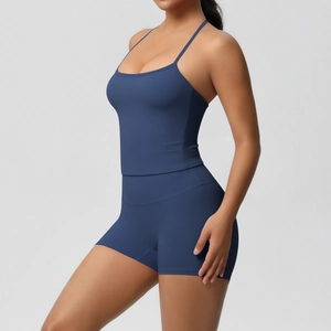 Close-up of high-waist yoga shorts and strappy camisole in navy blue matte fabric