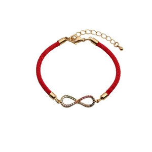 Detail of red braided infinity bracelet with gold-plated charm and colorful cubic zirconia