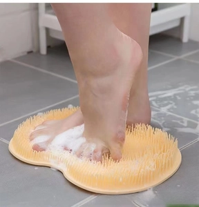 Detail showing soft silicone bristles of the foot massage mat with soapy bubbles on floor