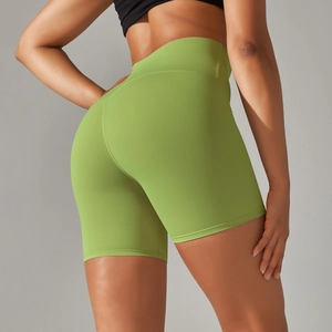 Macro detail of avocado green high-waisted yoga shorts with matte texture and fine stitching
