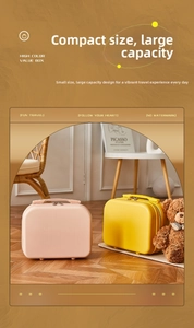 Pink and yellow hard shell mini suitcases with handles and metal zippers in home setting