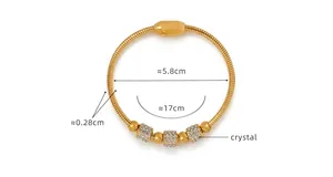 Detail view of gold crystal bangle with size measurements 17cm circumference and 5.8cm diameter